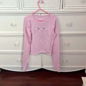 pink long sleeved baby tee with white and blue flowers